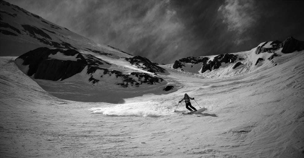 Skier descending towards the Argentierre Glacier in the back country behind the Grand Montets Ski Area, Chamonix, France